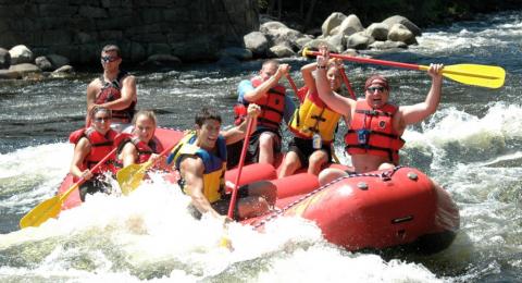 people enjoying a whitewater rafting adventure in the Adirondack Mountains