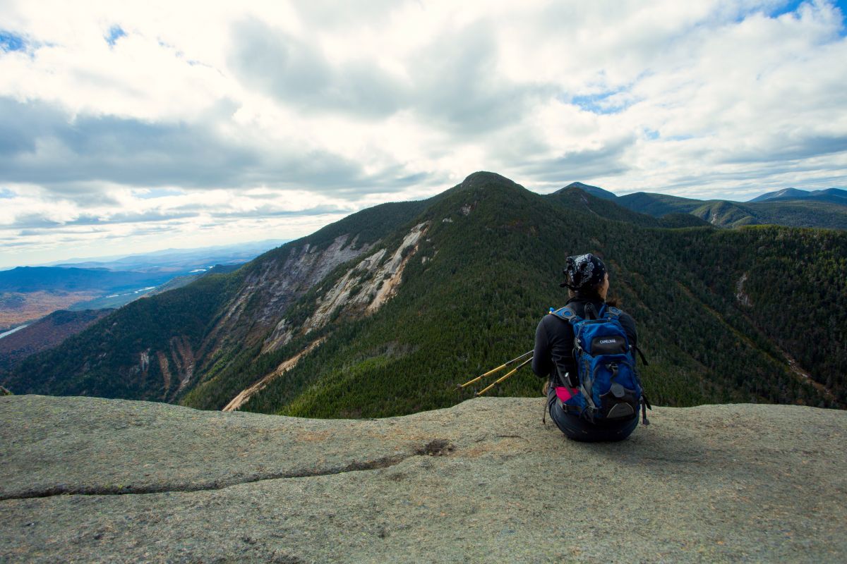 hiker looking out over the scenic view from Haystack Mountain; image credit to Jordan Craig Media