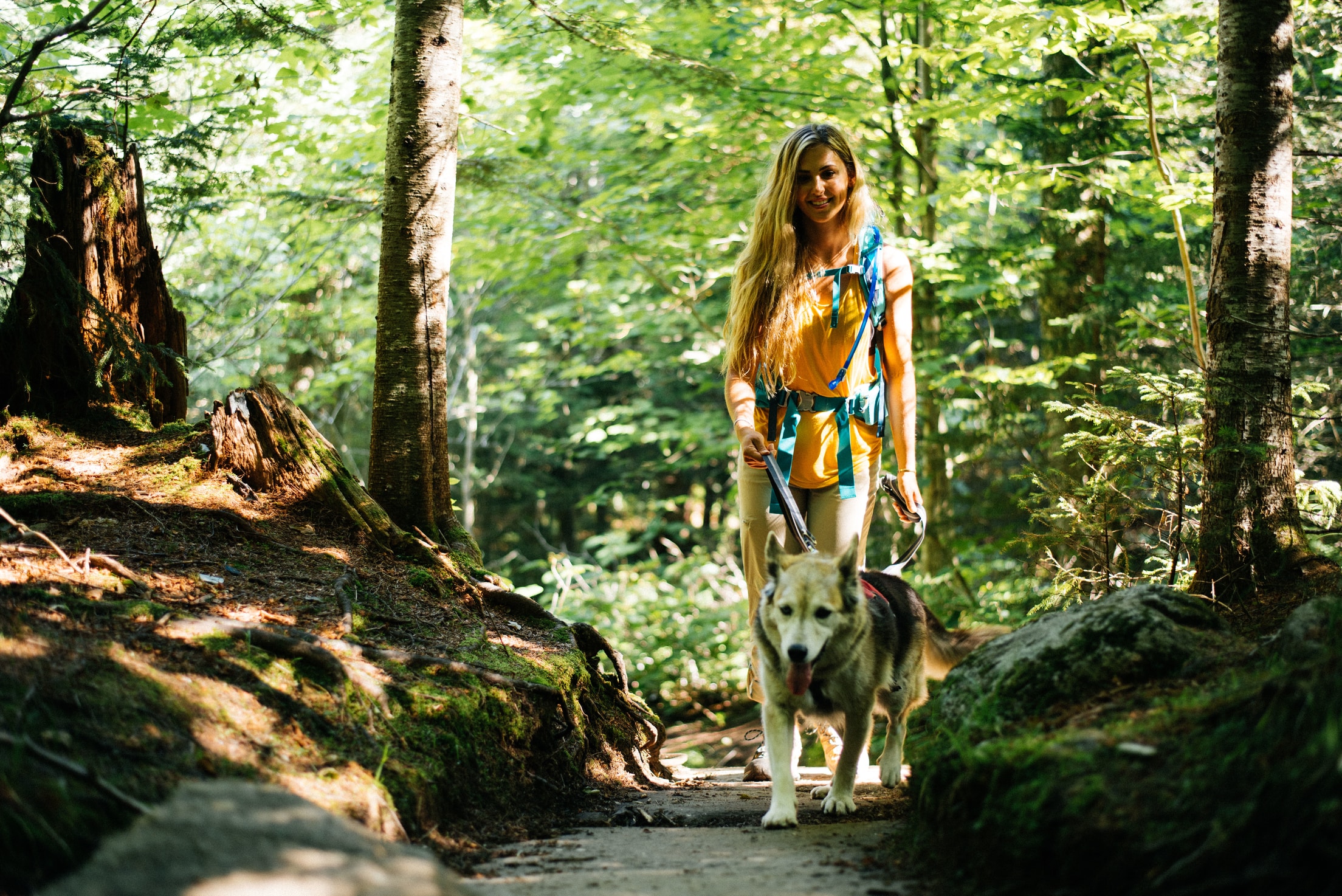 woman hiking with her dog in the Adirondacks