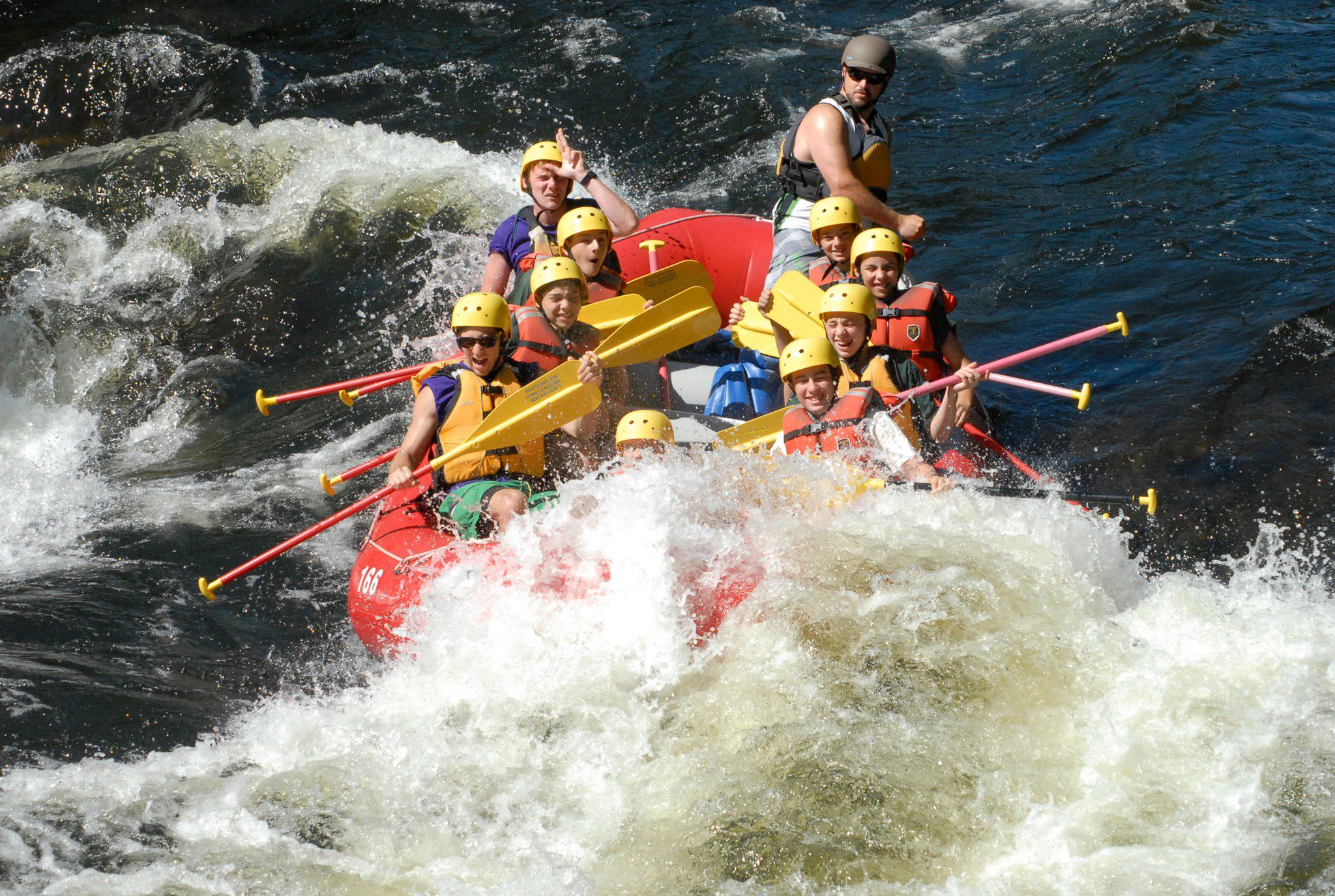 group of people whitewater rafting in the Adirondacks
