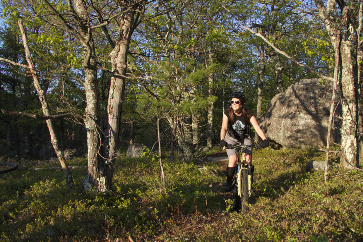 girl mountain biking in the Adirondacks