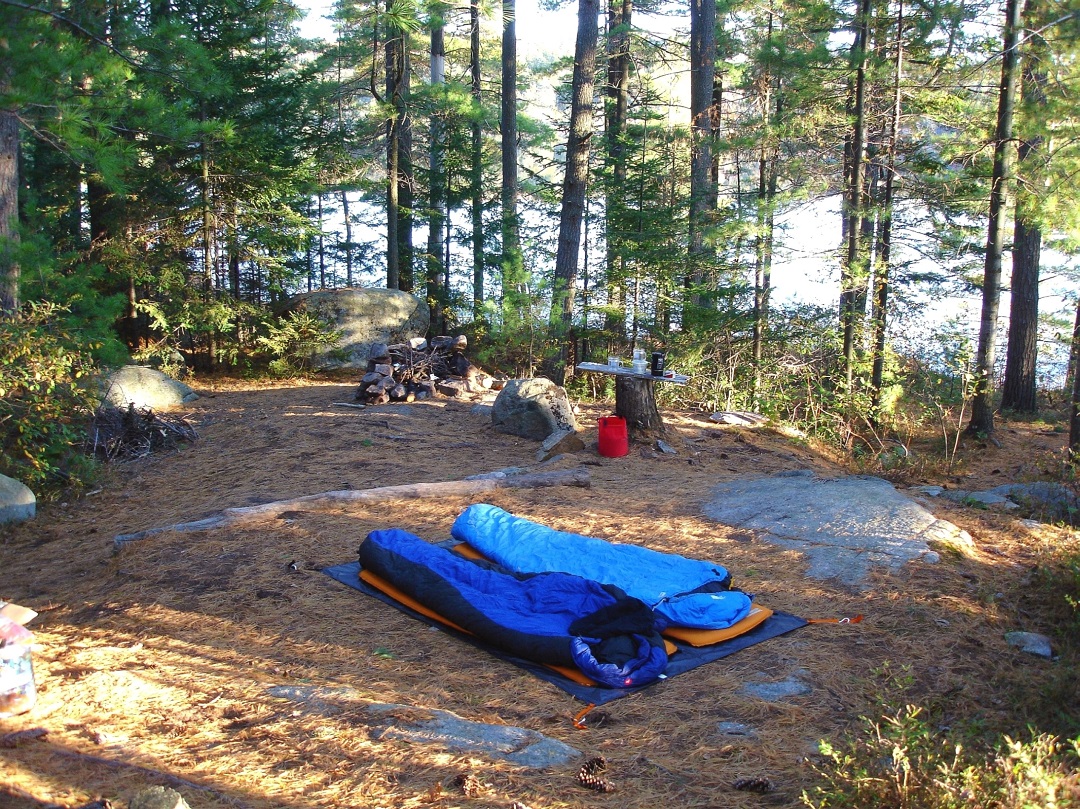 sleeping bags on the ground at a backcountry campsite