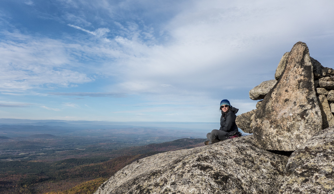 woman sitting at top of Jay Mountain