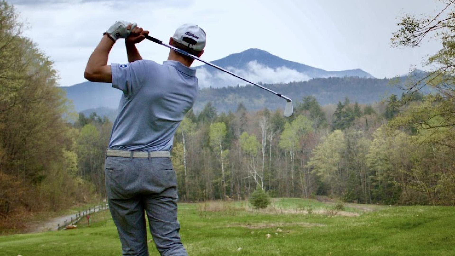 Golfer with mountain