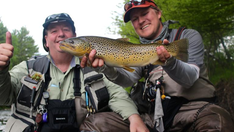 two men fishing in the Adirondacks celebrating a catch