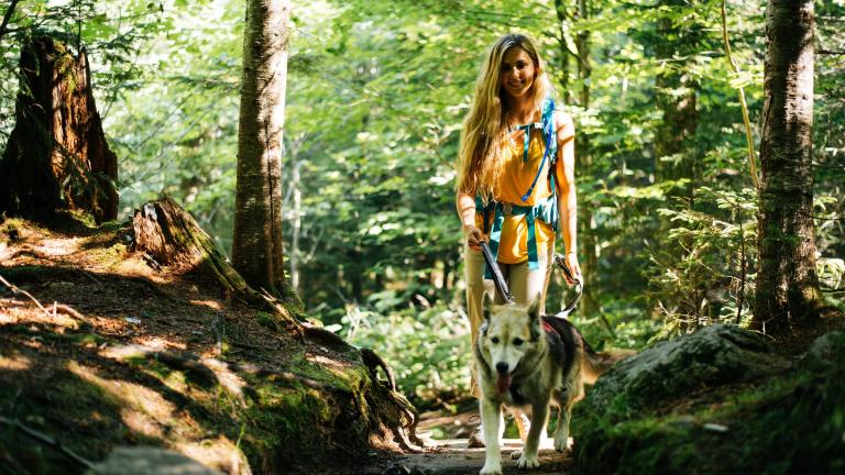 woman hiking with her dog in the Adirondacks