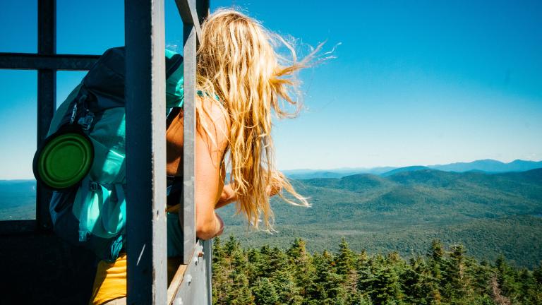 girl in a fire tower during a summer hike in the Adirondacks