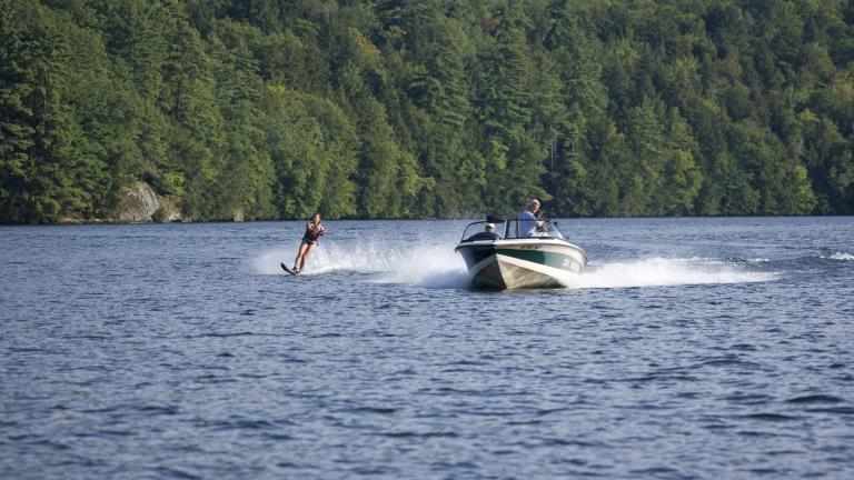 boating and water skiing on an Adirondack lake