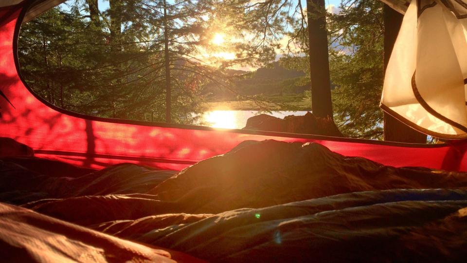 view through the opening of a camping tent in the Adirondacks