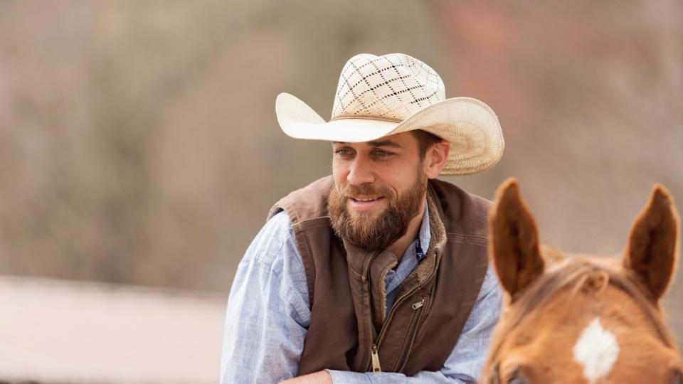 cowboy at Adirondack dude ranch on a horse