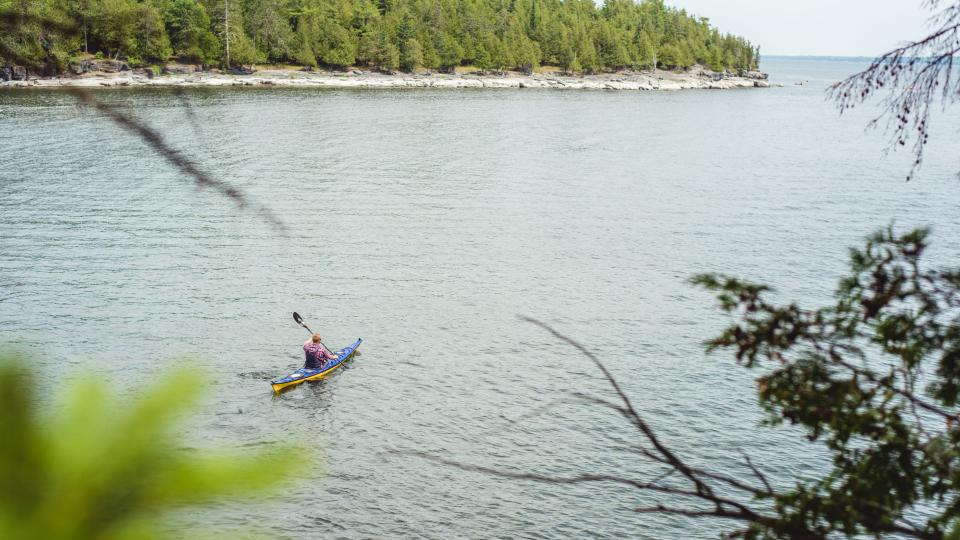 man kayaking on Lake Champlain in the Adirondacks