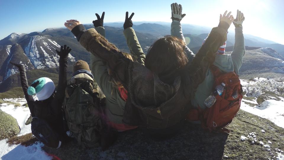 friends at the top of an Adirondack mountain in winter