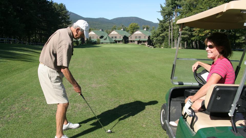 man and woman golfing in the Adirondacks