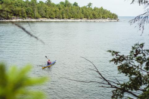 man paddling in the Adirondacks during the summer