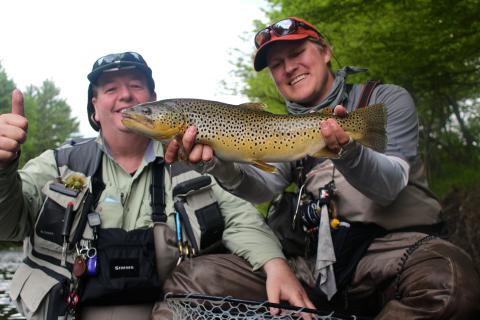 two men celebrating catching a fish